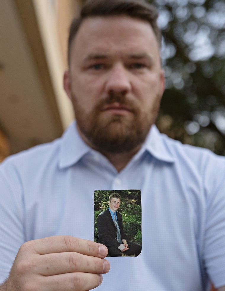 Joseph Cleveland holds a picture of himself as a young man.