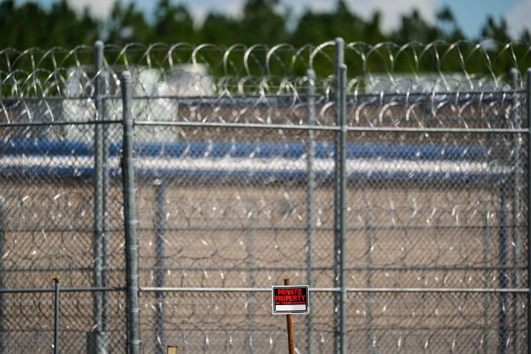 The perimeter fencing at the Folkston ICE Processing Centre, a private property sign is in front