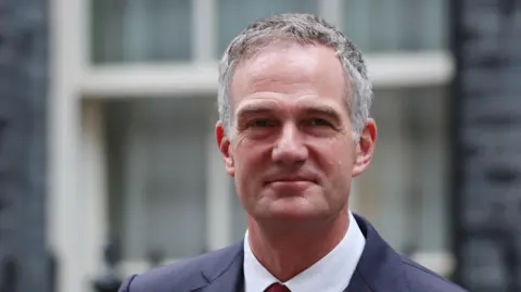 EPA British Secretary of State for Science, Innovation and Technology Peter Kyle departs a cabinet meeting at Downing Street in London. He has short, sharp grey hair and is wearing a smart suit.