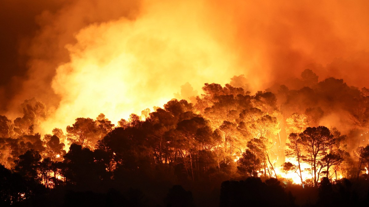 Woman dies and thousands flee ‘hellish’ destruction