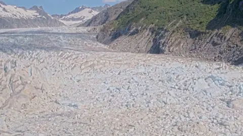 USGS/Reuters Chunks of ice are seen floating downstream past mountains in a screengrab from Suicide Basin in Alaska