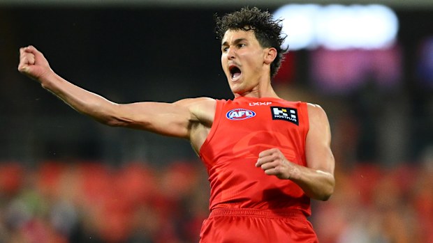 Wil Powell of the Suns celebrates kicking a goal.