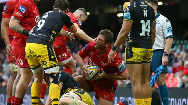 Alec Hepburn of the Scarlets celebrates after scorin a try during the United Rugby Championship match between the Dragons and Scarlets at the Principality Stadium