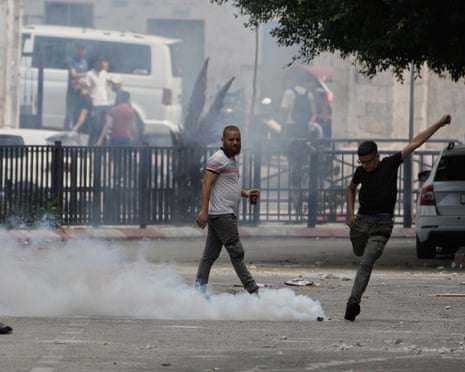 A Palestinian kicks a teargas canister during an Israeli military raid in the West Bank city of Nablus on Wednesday, 27 August 2025.