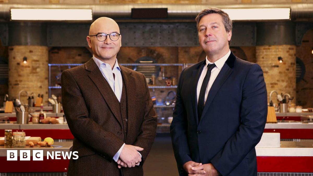Dymtro Chubenko stands in front of a pile of Russian missile and drone parts