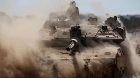 EPA Israeli tanks manoeuvre along the Israel-Gaza perimeter, in southern Israel (19 August 2025)