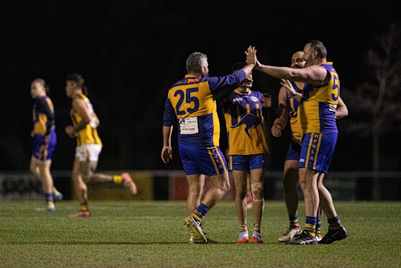 Ferras Merhi (right) high-fives business partner Sammy Saad during a game for Sunshine Thirds in early August. 