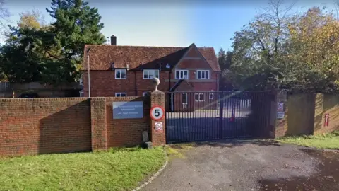 Google A Google Maps picture of Huntercombe Hospital, a two-storey brick building behind a black gate.