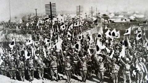 Universal History Archive/Universal Images Group via Getty Images Photographic print of The Japanese troops in Nanjing after the city's conquest in 1937