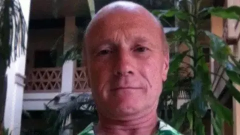 Facebook A head and shoulders picture at a man in a green shirt