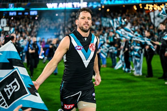 Power star Travis Boak runs on to an AFL ground for the final time as a player.
