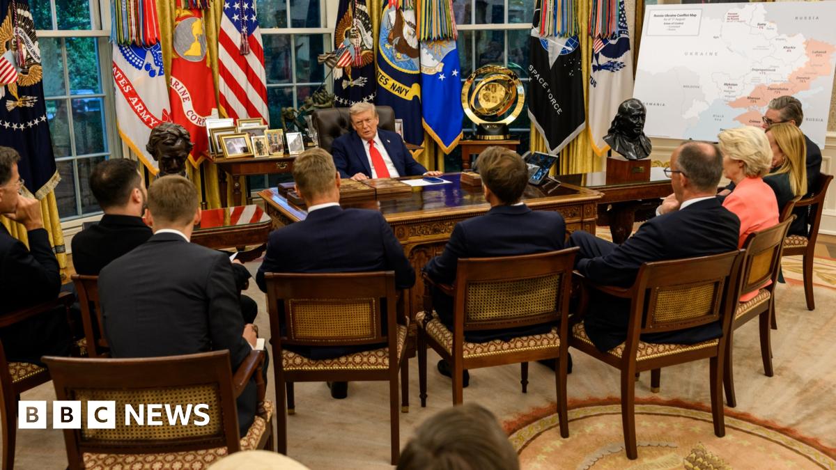 Donald Trump talks to European leaders across a table in the Oval Office.