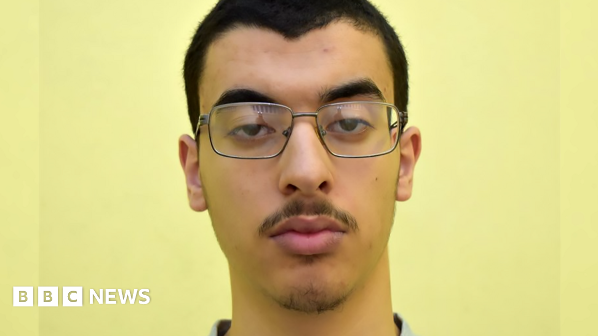A headshot of Hashem Abedi wearing glasses facing the camera against a yellow background.