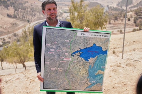 Bezalel Smotrich holds a map that shows the E1 settlement project during a press conference near the settlement of Maale Adumim, in the Israeli-occupied West Bank.