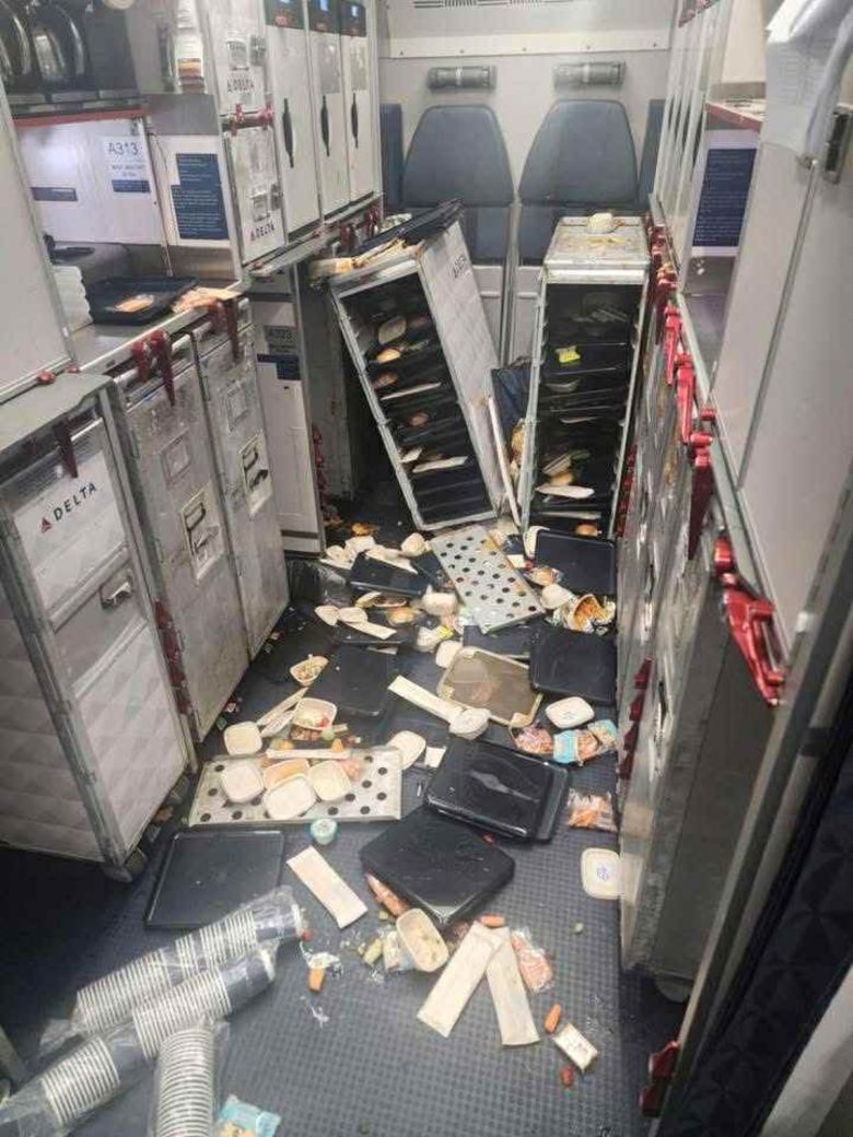 Plane service carts and food items thrown about after turbulence during the Delta flight, on July 30, 2025.