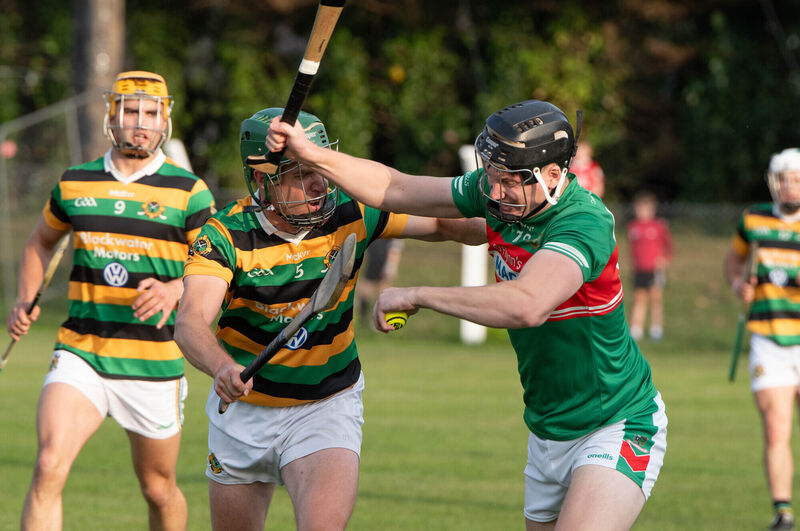 Fr O'Neill's Peter Hassett holds off the challenge from Glen Rovers' Brian Moylan. Picture: Howard Crowdy