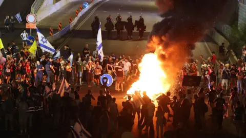 EPA Demonstrators supporting the families of Israeli hostages held by Hamas in Gaza light bonfires as they block the Ayalon main highway during a protest rally in Tel Aviv, Israel, 01 September 2024.