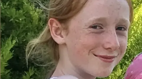 Family handout A picture of Ruth Szymankiewicz, a teenage girl who is smiling at the camera and has shoulder-length ginger hair.