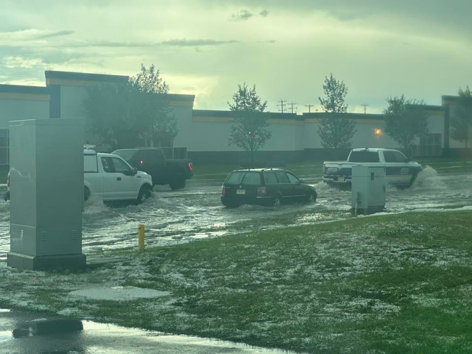 Vehicles drove through flooded streets in Airdrie after Thursday’s storm brought heavy rain and hail.   5/5        Ask ChatGPT