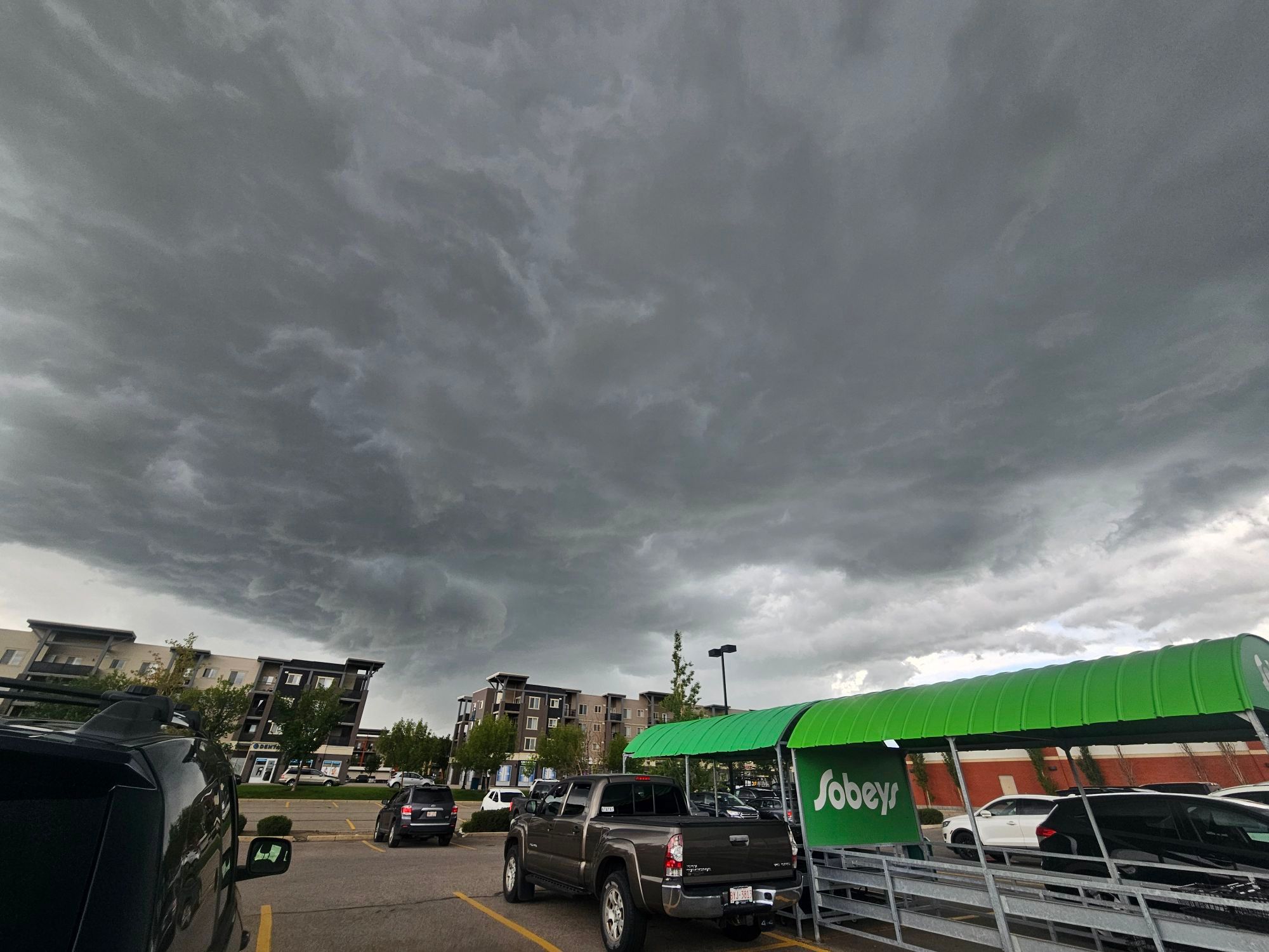 Dark storm clouds loomed over Airdrie on Thursday afternoon before heavy rain, hail and flash flooding hit the city.