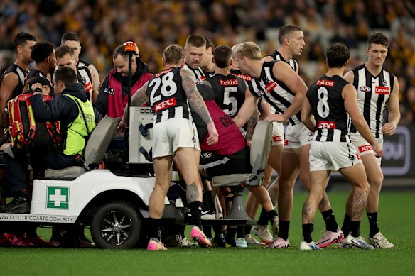 Collingwood players show their concern for teammate Jeremy Howe, who injured and stretchered off the ground in the opening moments of Thursday night’s match against Hawthorn.