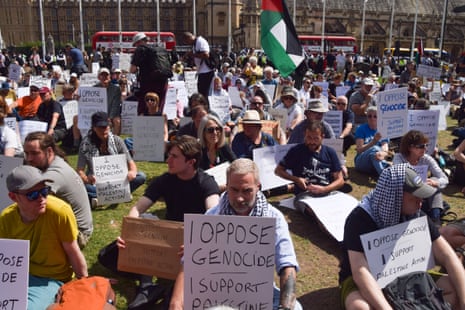 People in Parliament Square hold placards on 9 August 2025.
