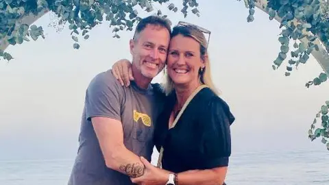 Family handout A husband and wife on holiday. They are smiling and look happy. 