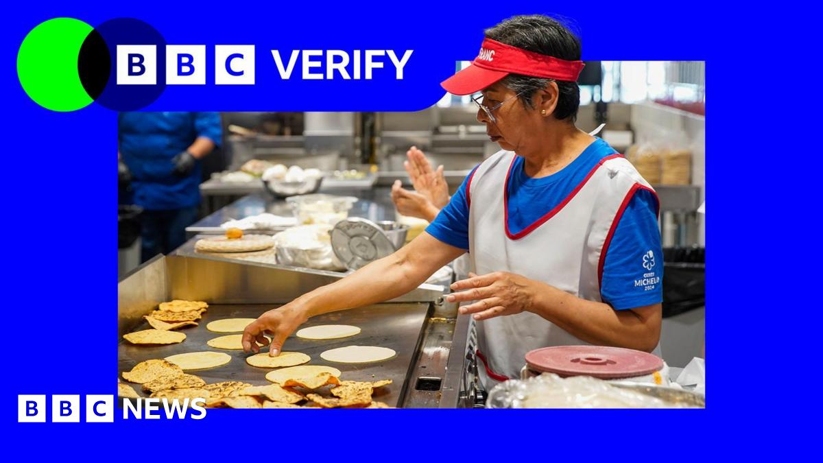 A woman flipping tortillas on a grill in a restaurant kitchen in America