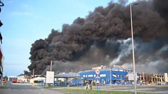 Heavy black smoke billowing above a group of buildings in Mukachevo, western Ukraine