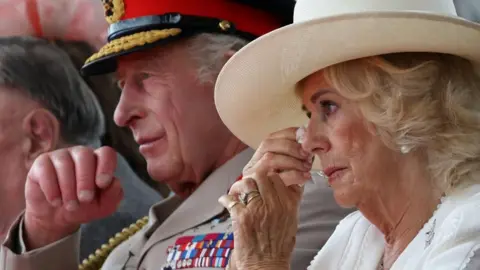 PA Queen Camilla appears to wipe away a tear as Yavar Abbas recounted his recovery from cancer  