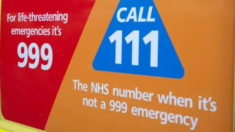 Getty Images/Mike Kemp A logo of the NHS 111 call service with the 999 number next to it.