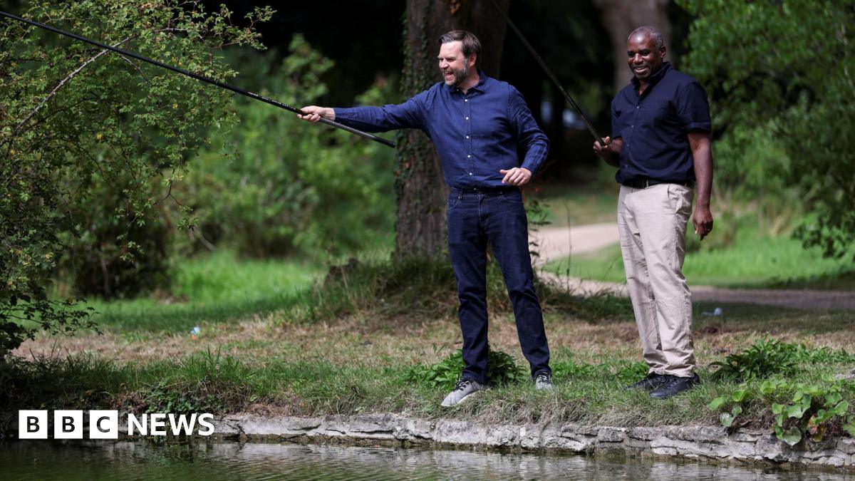 Foreign Secretary David Lammy fishing with US vice president JD Vance at Chevening House in Kent. Both men are wearing blue shirts, JD Vance is in jeans and Lammy is in beige chinos.