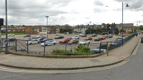 Google A street view image of a large car park taken from a road in the corner