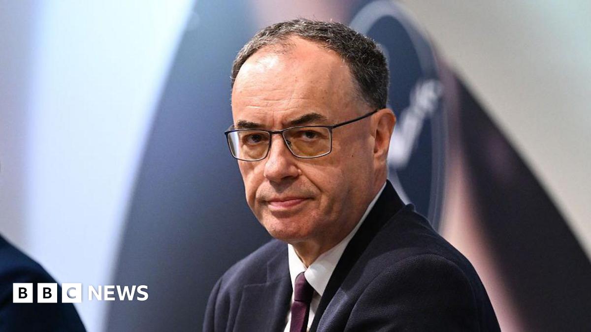 Andrew Bailey, Bank of England governor, looks straight at the camera. he's wearing glasses and a dark suit.