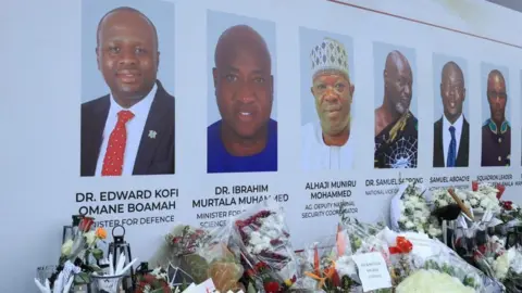 EPA Tributes and flowers placed at a mourning site for eight people, including two government officials, who died in a military helicopter crash
