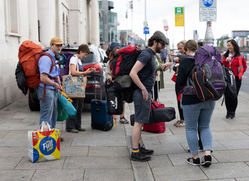 People wait on the quays in Dublin for coaches travelling to the festival in Co Waterford. Photograph: Sam Boal/Collins