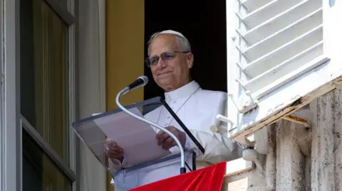 Reuters Pope Leo XIV leads the Angelus prayer from his window at the Vatican