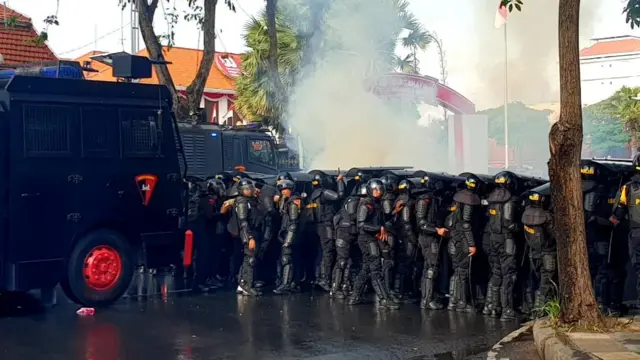 A group of police outside the compound