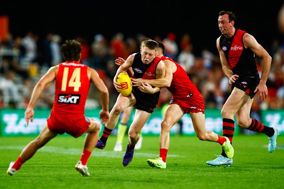 Angus Clarke is tackled by Ben Ainsworth.