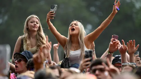 Getty Images Fans soak up the atmosphere during Leeds Festival at Bramham Park 