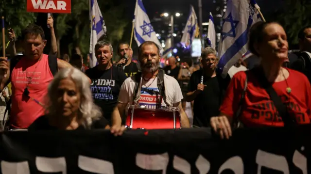 Israelis protest in streets at night