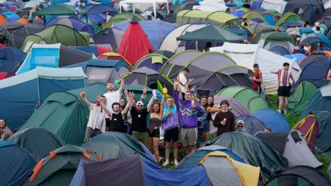 PA Media A group enjoying the campsite at Electric Picnic with a variety of multi-coloured tents
