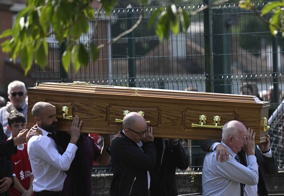 The coffin is carried in to the funeral of Stephen Brannigan (Mark Marlow/PA)