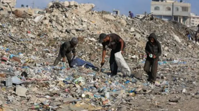 Palestinians search for food scraps or saleable materials spending hours in the garbage dumps around the Firas Market despite the heavy odor in Gaza City