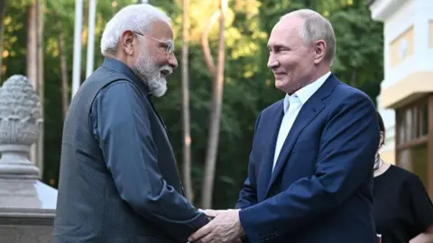 Getty Images In this pool photograph distributed by the Russian state agency Sputnik, Russia's President Vladimir Putin welcomes Indian Prime Minister Narendra Modi for an informal meeting at the Novo-Ogaryovo state residence, outside Moscow, on July 8, 2024. 