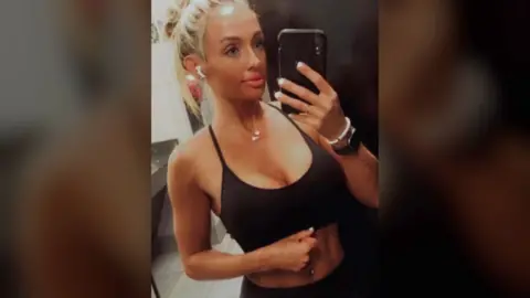 Harford Co Sheriff's Office Rachel Morin takes a selfie in a mirror wearing a black sports bra