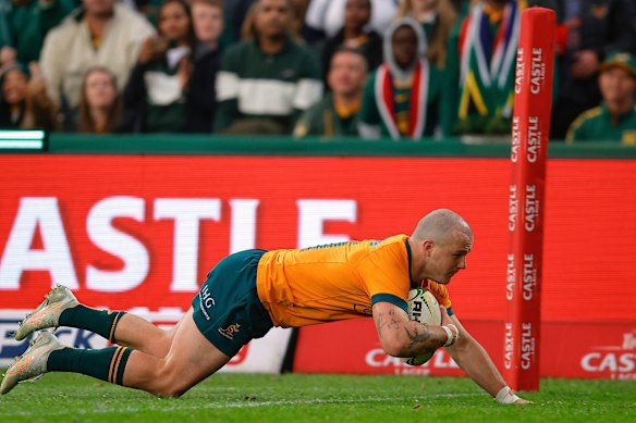 Australia’s Dylan Pietsch dives over the line to score a try against South Africa.