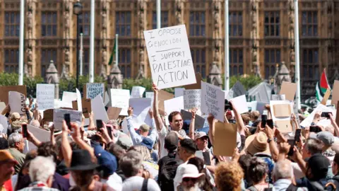 EPA Protestors at Parliament Square holding up placards saying I oppose genocide, I support Palestine Action