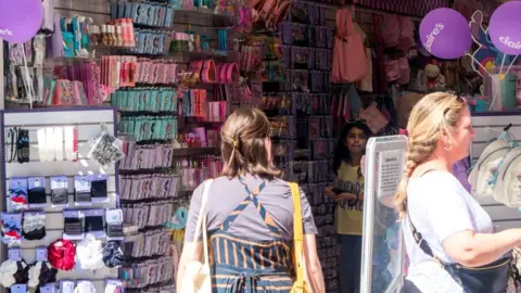 Matthew Chattle/Future Publishing via Getty Images Shoppers inside a Claire's store with rows of merchandise
