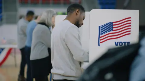 Getty Images Voters casting their votes at a US election polling station